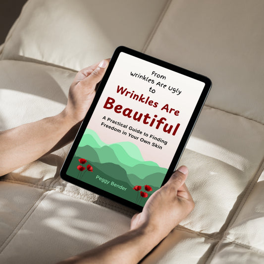 Person holding a tablet with a book cover titled 'From Wrinkles Are Ugly to Wrinkles Are Beautiful' on a beige couch.